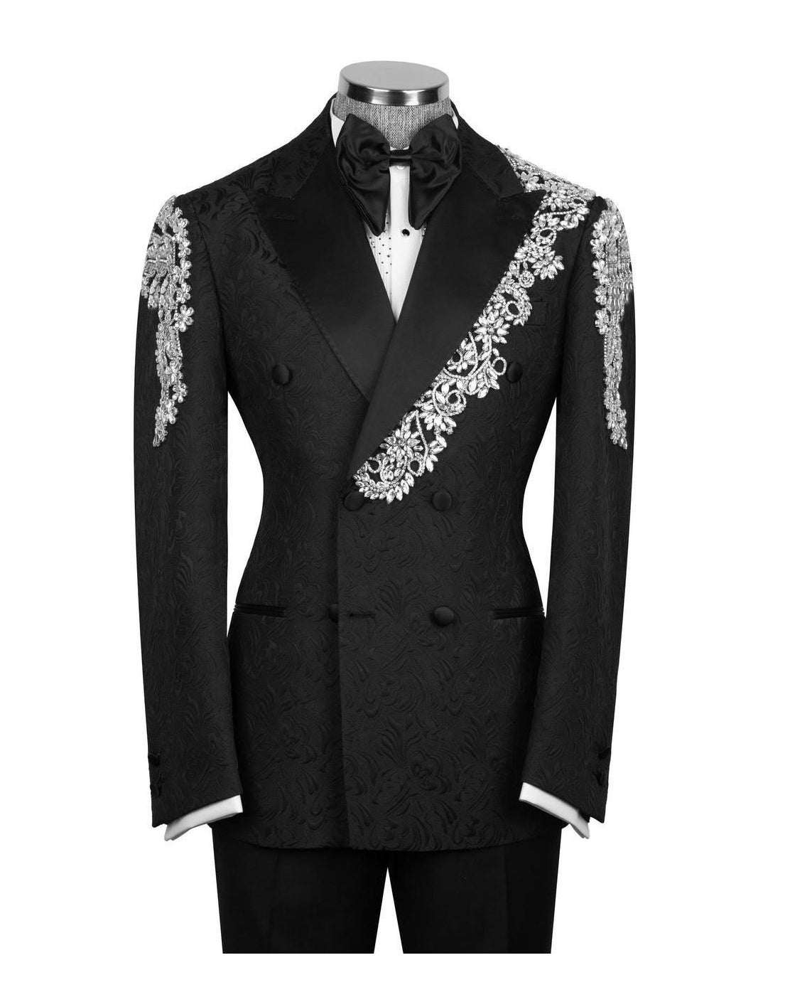 A black double-breasted tuxedo jacket with ornate silver lace embroidery on the lapels and shoulders, displayed on a mannequin with a black bow tie and white shirt against a white background.
