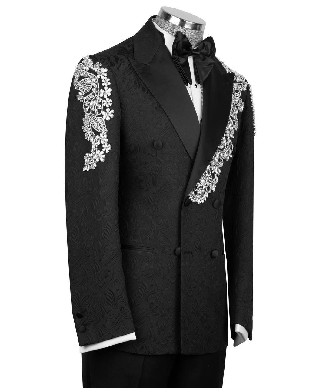 Black tuxedo with white floral embroidery on a mannequin against a white background