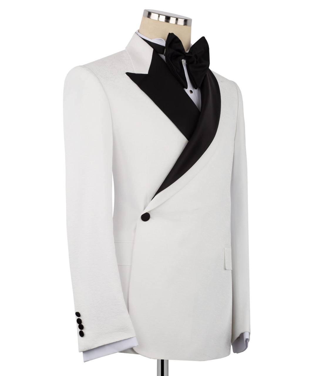 A white tuxedo jacket with black satin peak lapels, styled on a mannequin with a black bow tie and white dress shirt against a plain white background.