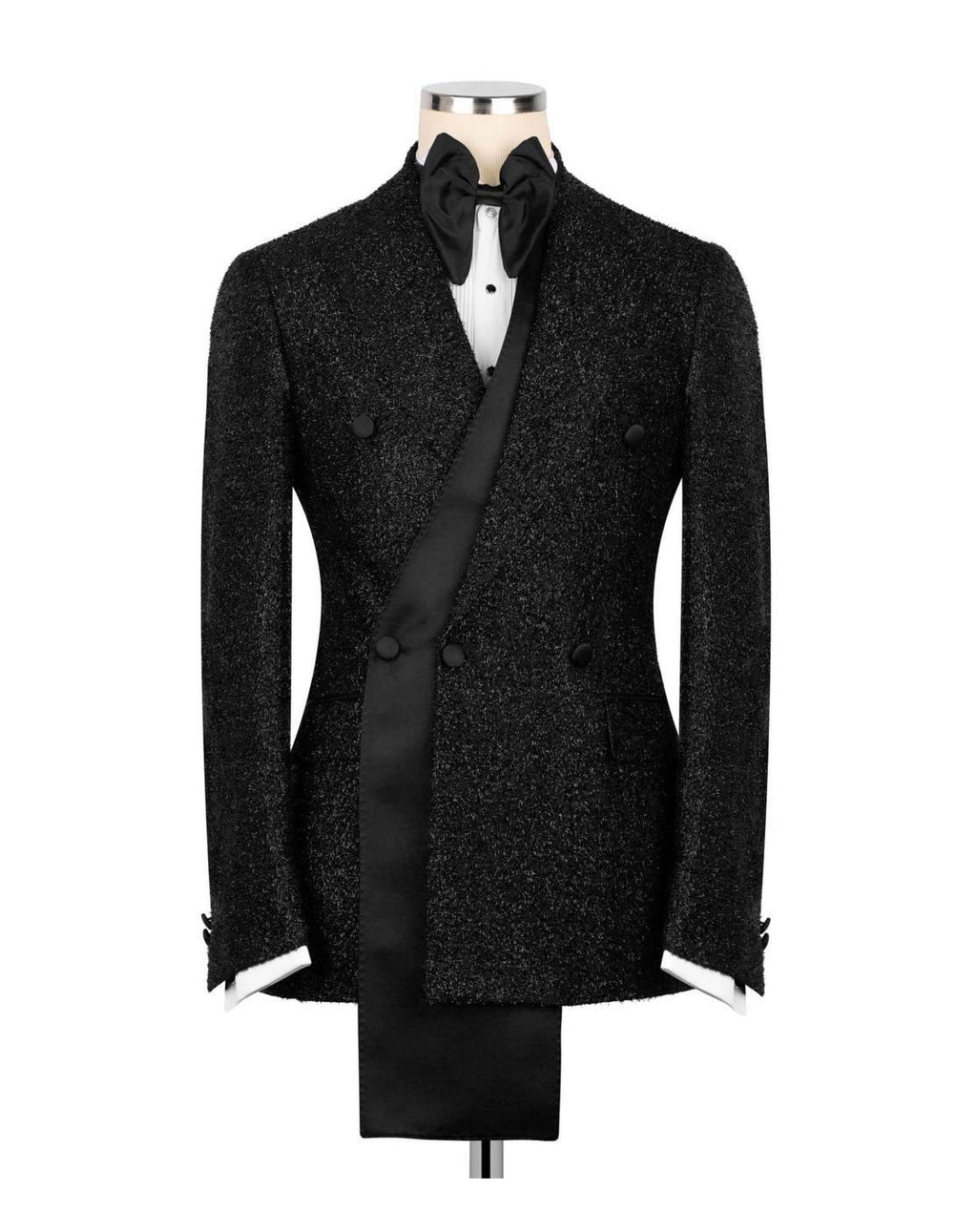 A black textured double-breasted tuxedo jacket displayed on a mannequin with a black bow tie, white shirt, and black waistcoat against a plain white background.