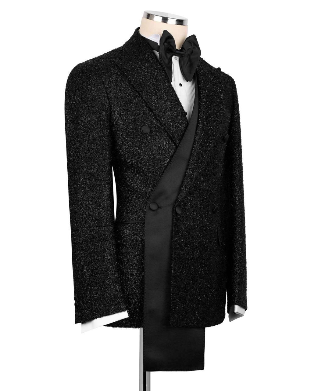 Black tuxedo on a mannequin against a white background