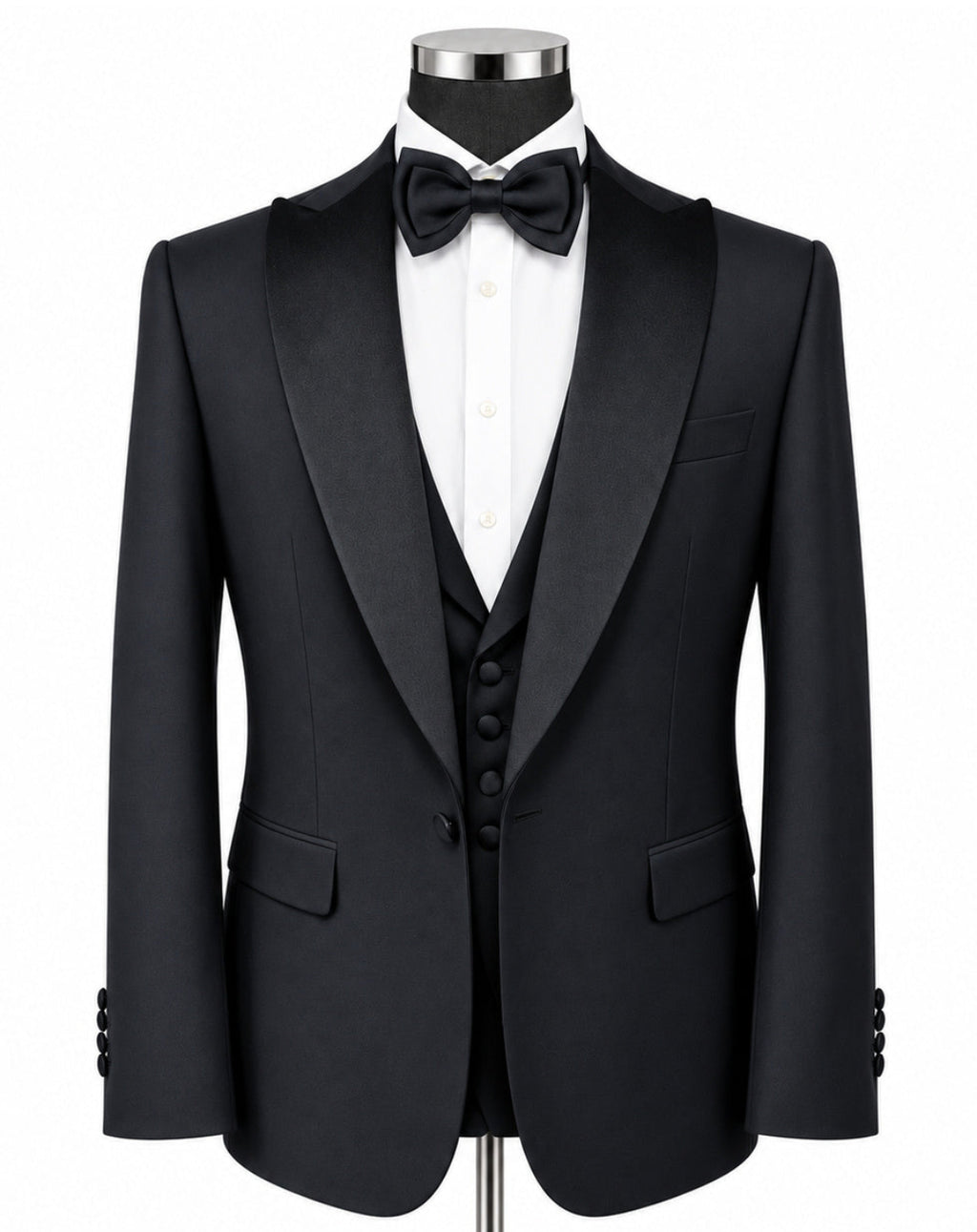 A black tuxedo jacket displayed on a mannequin torso with a white dress shirt, black bow tie, black vest, and a silver stand against a plain white background.