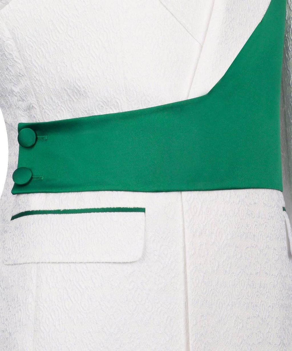 Close-up of a white garment with green accents and buttons on a white background