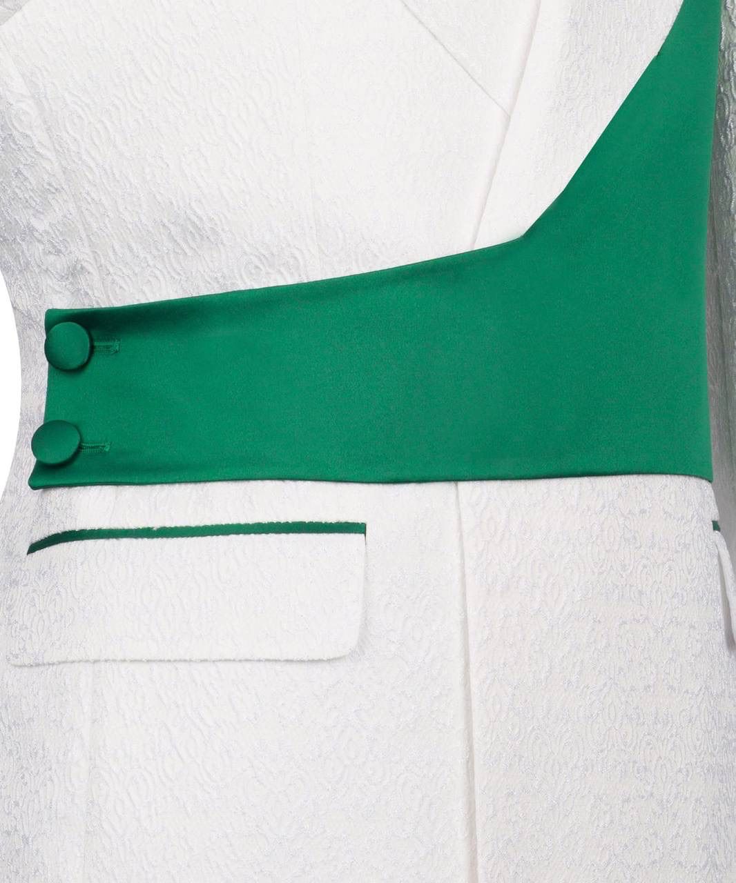 Close-up of a white garment with green accents and buttons on a white background