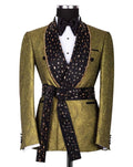 An olive green jacquard tuxedo jacket with black beaded lapels, a matching black beaded waist belt, and a black bow tie, displayed on a mannequin against a white background.