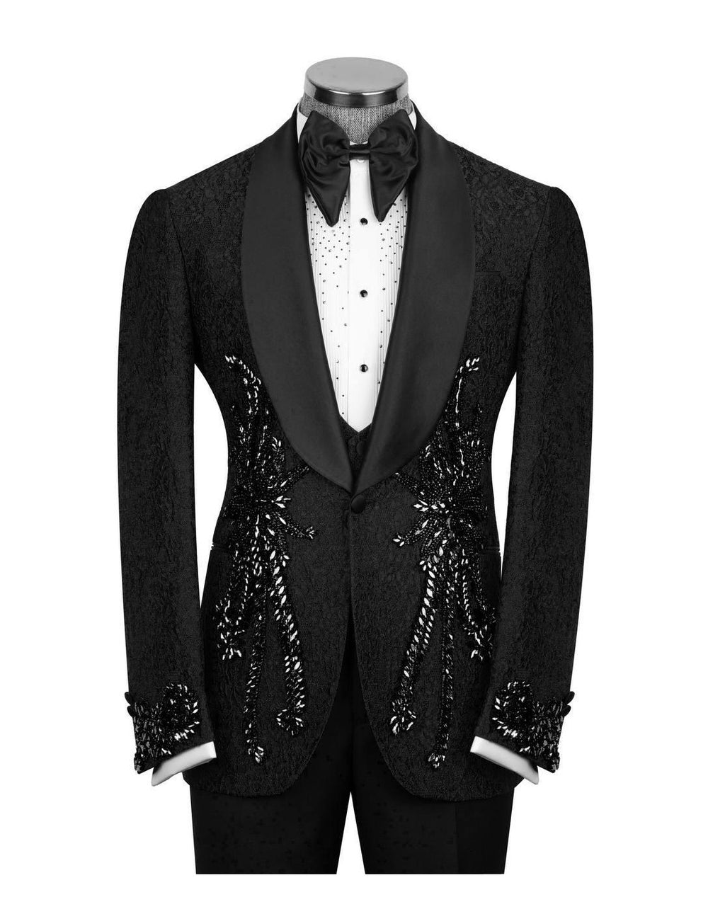 A black tuxedo jacket with ornate silver sequin and bead embellishments on the front, displayed on a mannequin with a black bow tie, white shirt, and black trousers against a white background.