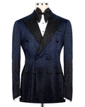 A dark navy blue double-breasted tuxedo jacket with a textured pattern, black satin peak lapels embellished with rhinestones, and a black bow tie, displayed on a mannequin against a white background.