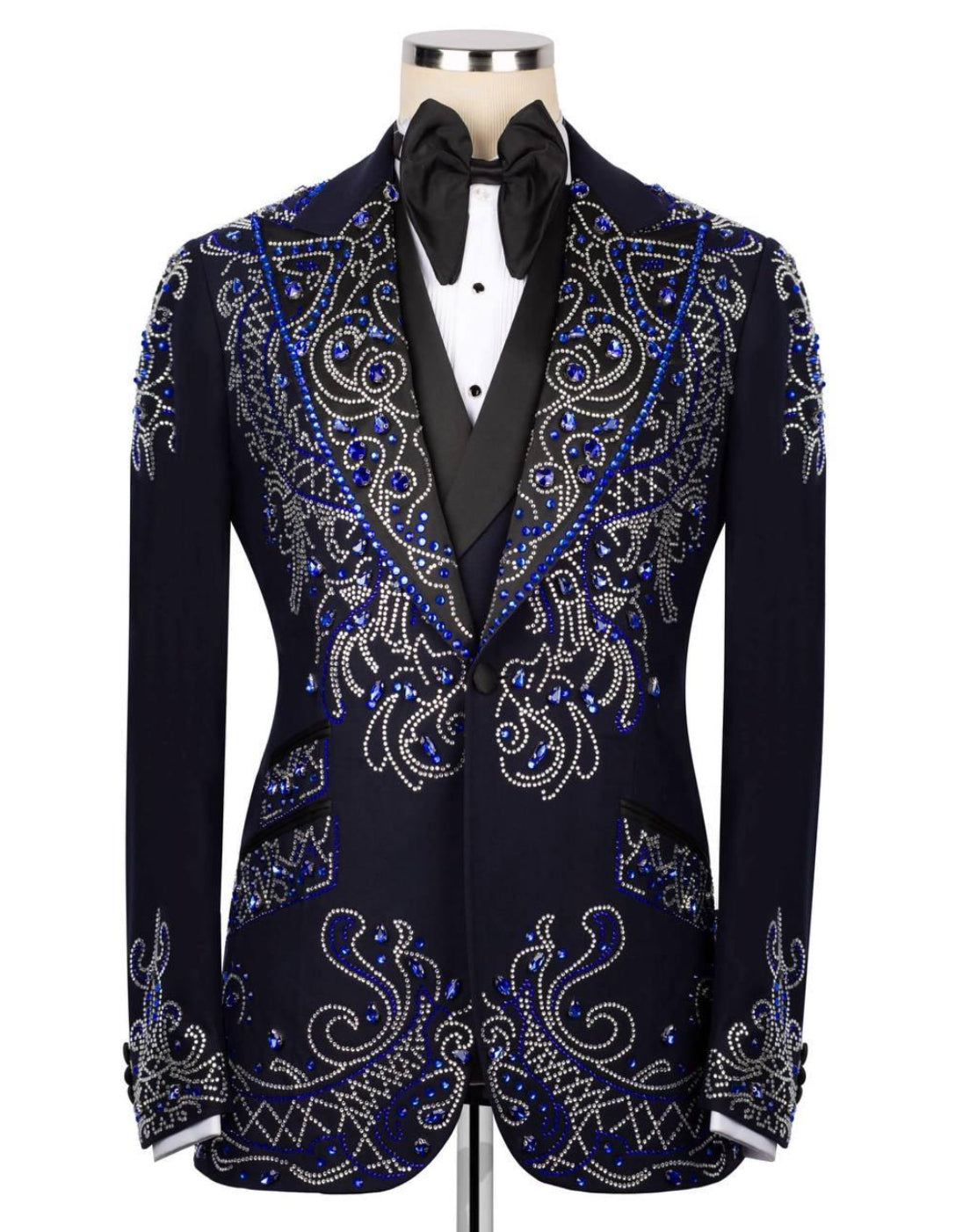 Black tuxedo with blue and silver embroidery on a mannequin against a white background