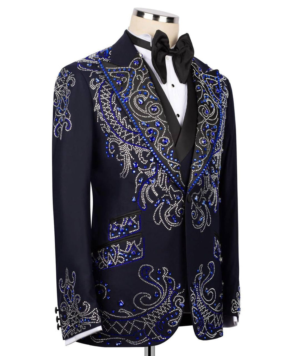 Decorative black tuxedo jacket with blue and silver embellishments on a mannequin.
