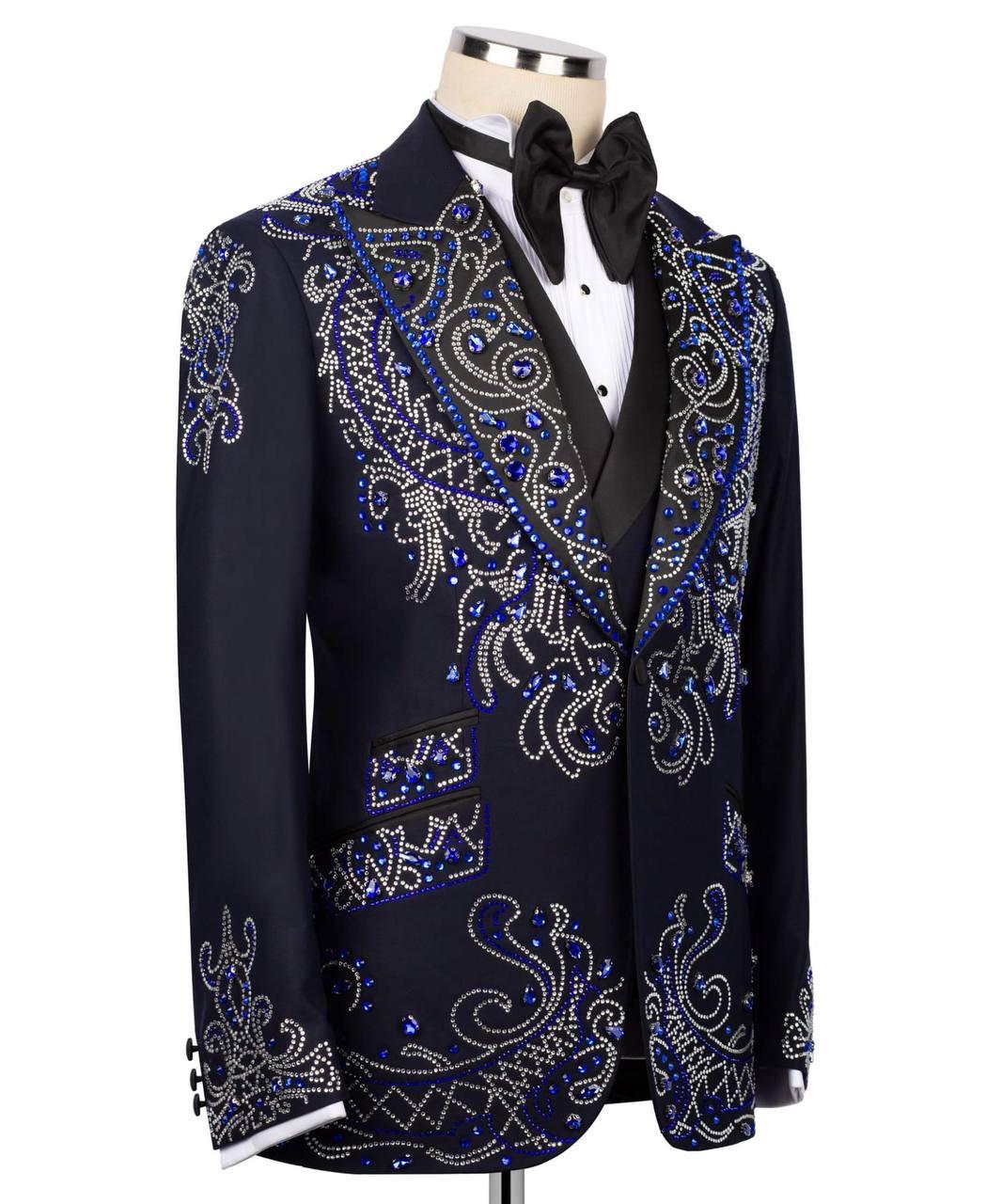 Decorative black tuxedo jacket with blue and silver embellishments on a mannequin.