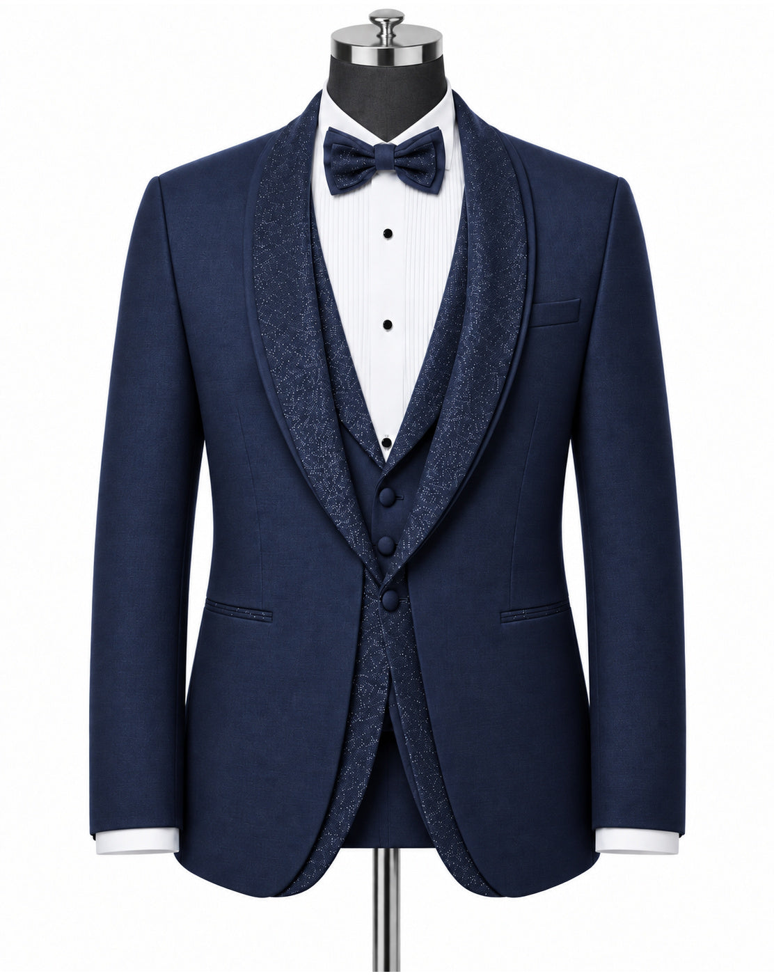 A navy blue formal tuxedo jacket with textured shawl lapels, displayed on a mannequin with a matching navy bow tie, white pinstriped shirt, and matching textured vest against a plain white background.