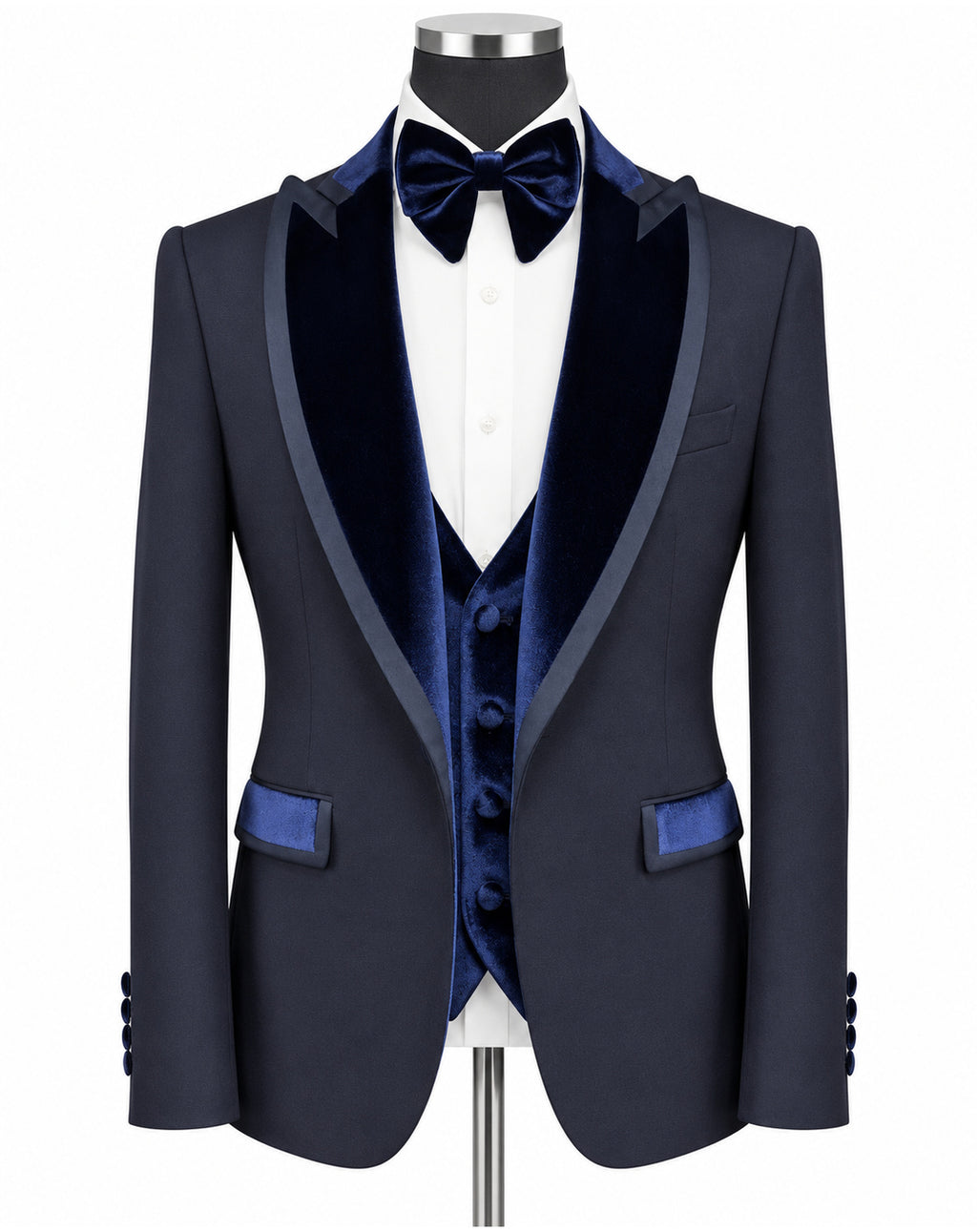A navy blue formal tuxedo jacket with dark blue velvet shawl lapels, a matching navy velvet vest, a navy bow tie, and a white dress shirt, displayed on a mannequin torso against a white background.