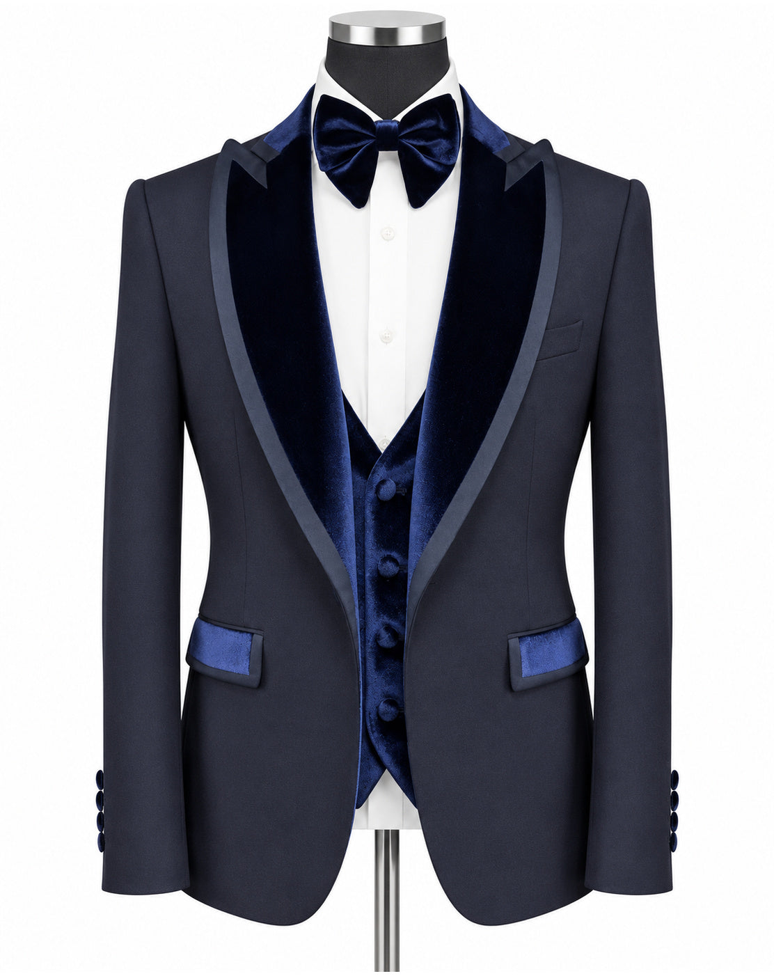 A navy blue formal tuxedo jacket with dark blue velvet shawl lapels, a matching navy velvet vest, a navy bow tie, and a white dress shirt, displayed on a mannequin torso against a white background.