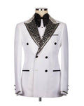 A white double-breasted tuxedo jacket with black lapels heavily embellished with silver rhinestones, displayed on a mannequin with a black bow tie and white shirt.