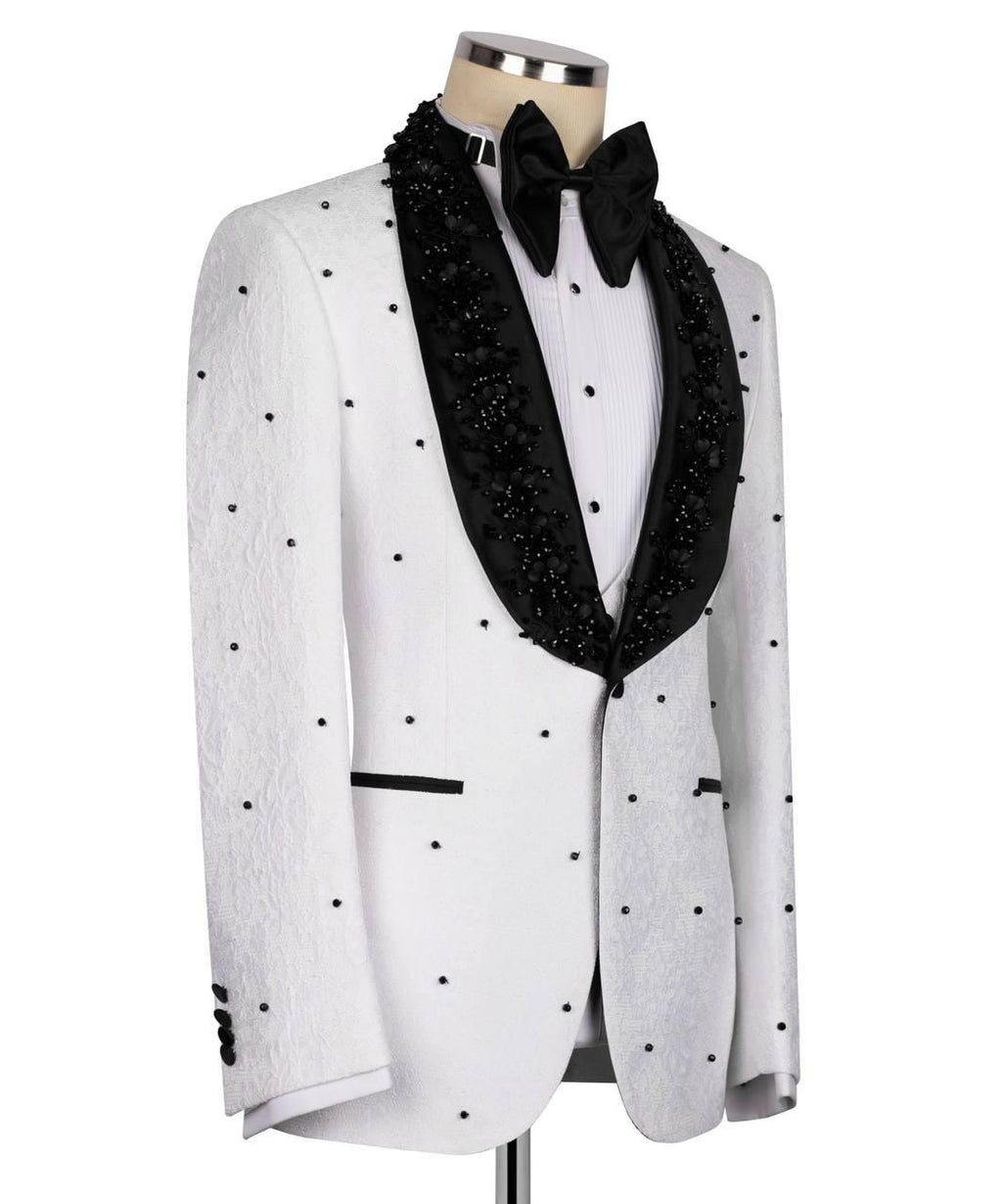 A white tuxedo jacket with black polka dots and black beaded lapels, styled on a mannequin with a black bow tie and white shirt against a white background.