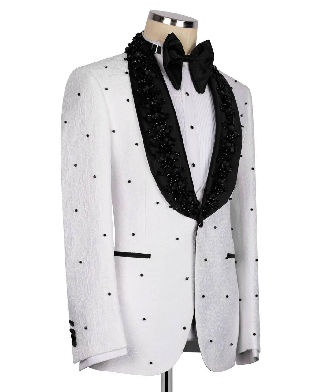 A white tuxedo jacket with black polka dots and black beaded lapels, styled on a mannequin with a black bow tie and white shirt against a white background.