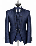 A men's three-piece suit in a textured navy blue fabric, displayed on a black mannequin with a white dress shirt and matching tie against a plain white background.