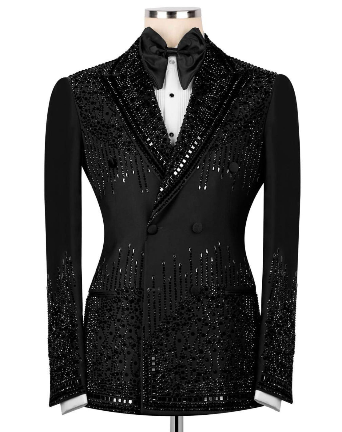 A black double-breasted tuxedo blazer heavily embellished with sequins and beads, styled on a mannequin with a black bow tie and white dress shirt against a plain white background.