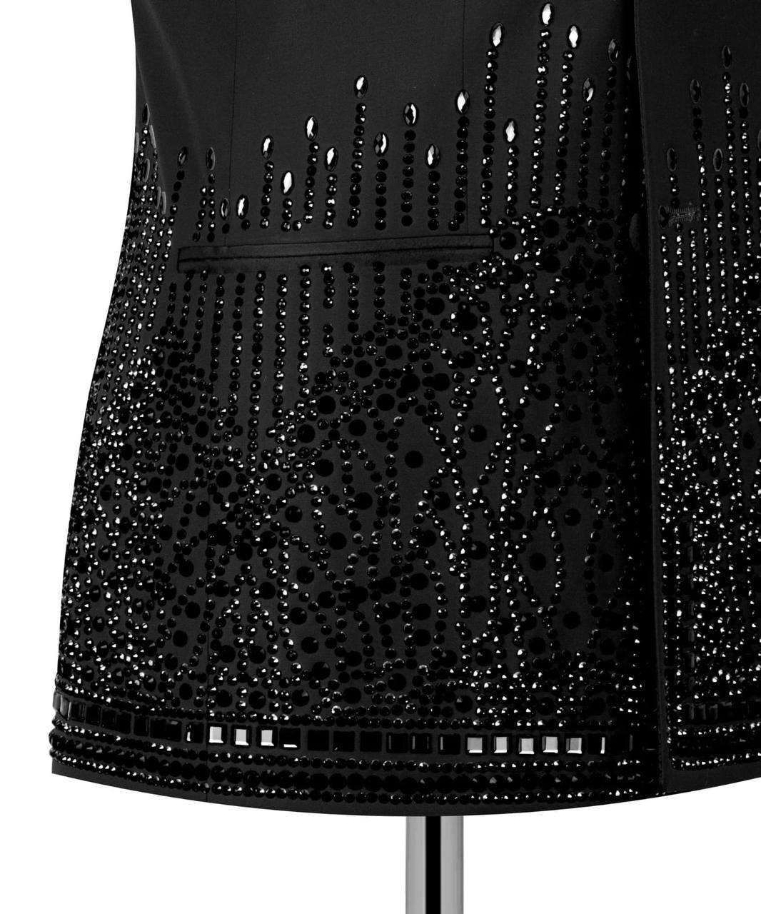 Close-up of a black embellished garment or accessory with dense bead, sequin, and rhinestone vertical patterns on a white background.