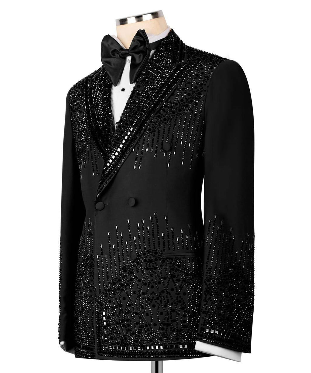 A black double-breasted tuxedo jacket with heavy silver bead and sequin embellishments, styled on a mannequin with a black bow tie and white shirt against a white background.