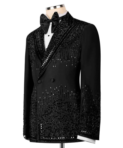 A black double-breasted tuxedo jacket with heavy silver bead and sequin embellishments, styled on a mannequin with a black bow tie and white shirt against a white background.