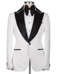 A white tuxedo jacket with black beaded shawl lapels, displayed on a mannequin with a white dress shirt, black bow tie, and black cufflinks against a light gray background.