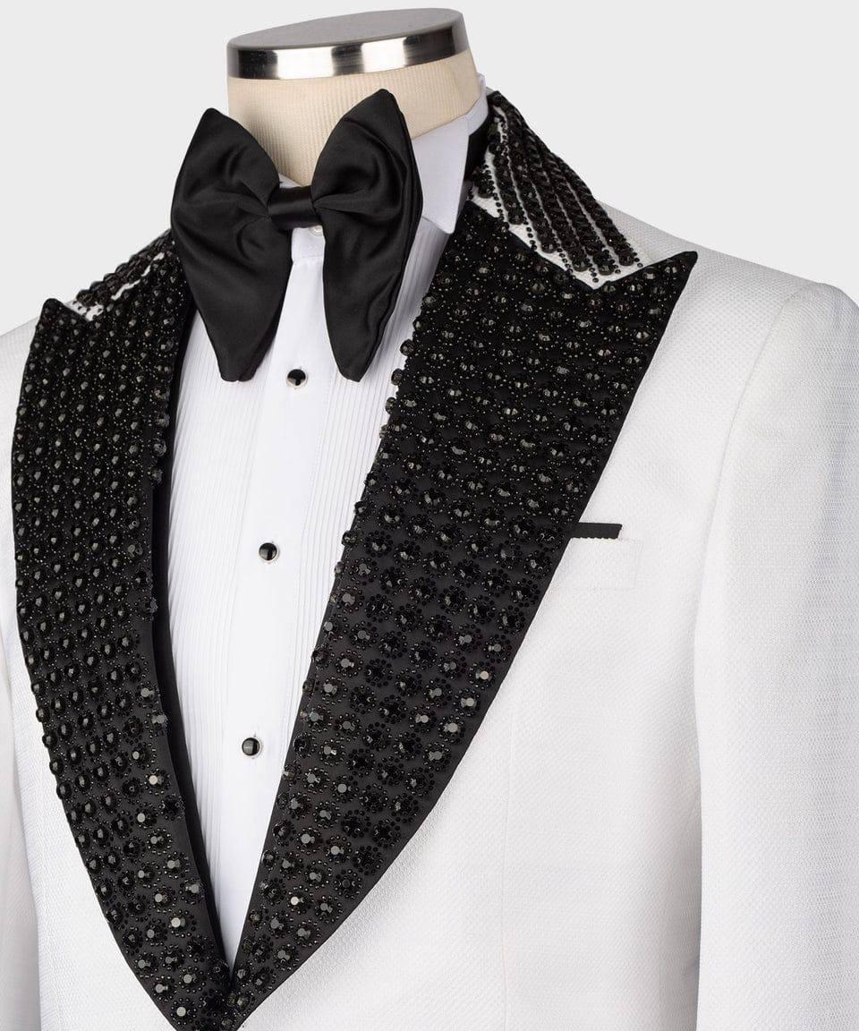 White tuxedo with black sequin lapels and bow tie on a mannequin against a white background
