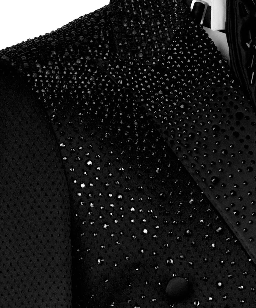Close-up of a black coat with a textured pattern on a white background
