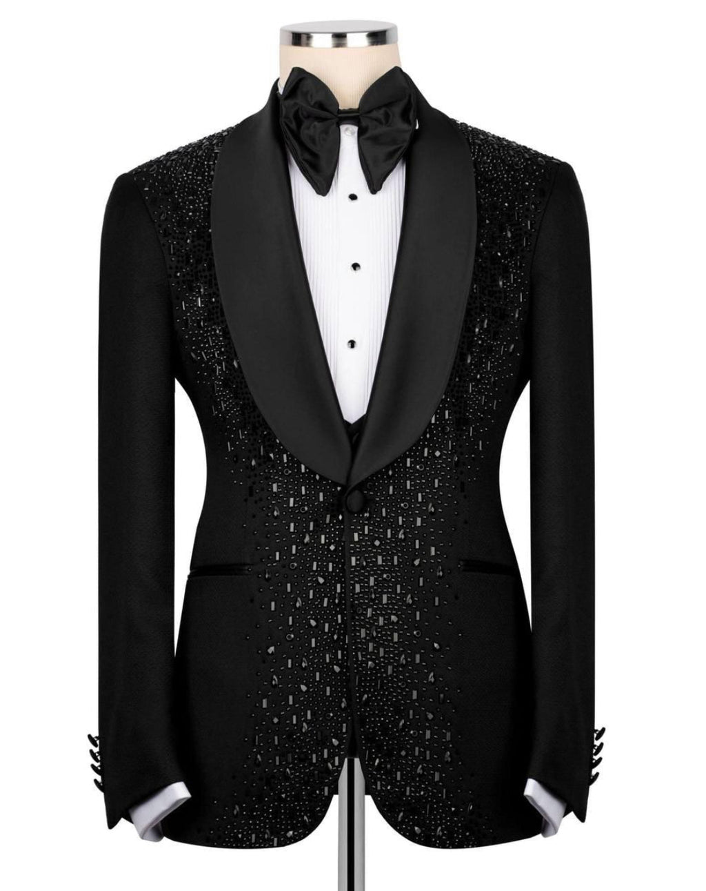 A black tuxedo jacket with sparkling silver beadwork, styled on a mannequin with a black satin bow tie, white dress shirt, and black bow tie.