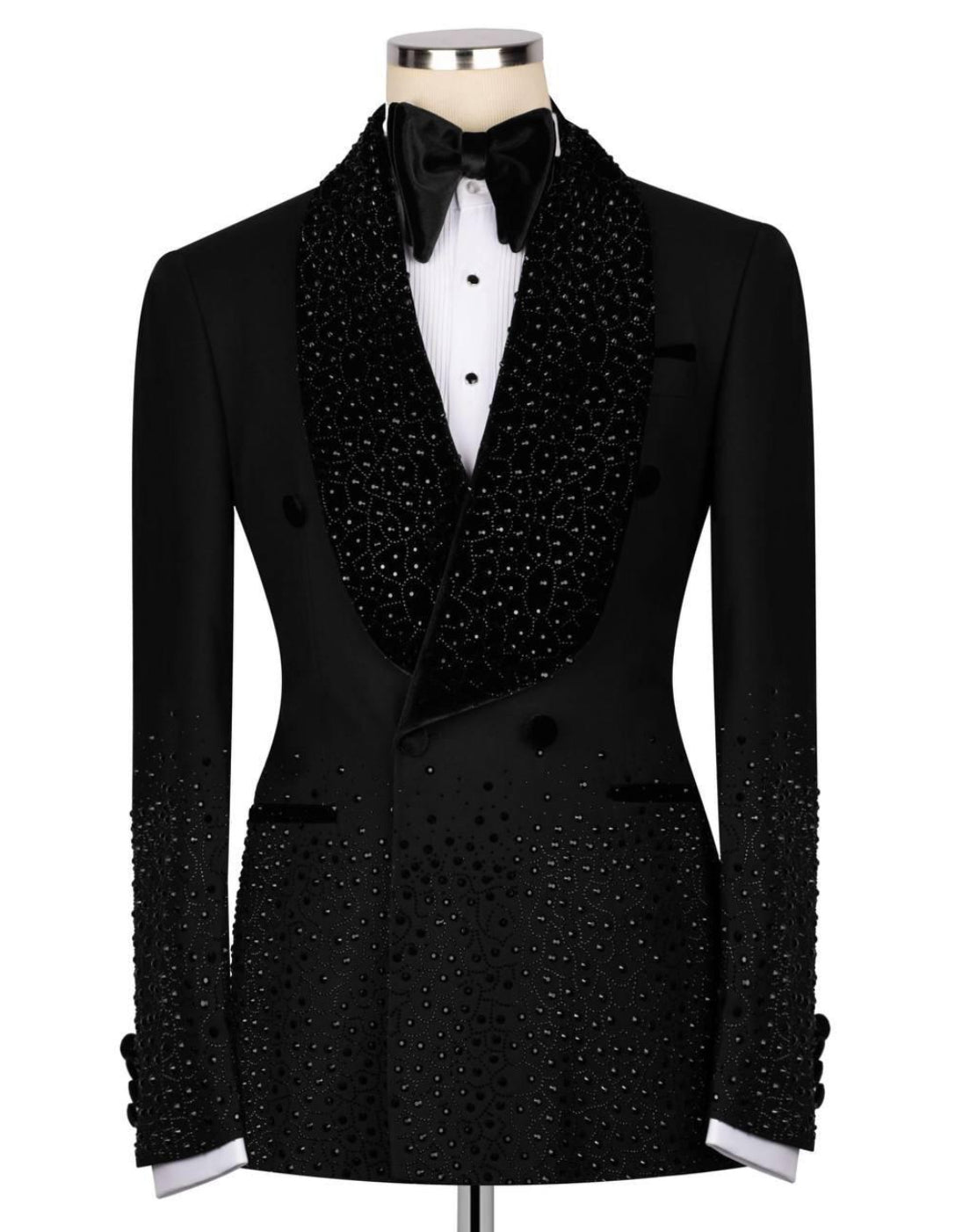 Black tuxedo with decorative lapels on a mannequin against a white background