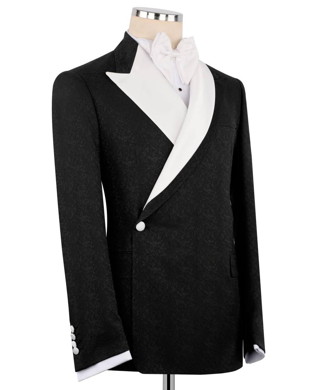 Black tuxedo jacket with white shirt and bow tie on a mannequin against a white background
