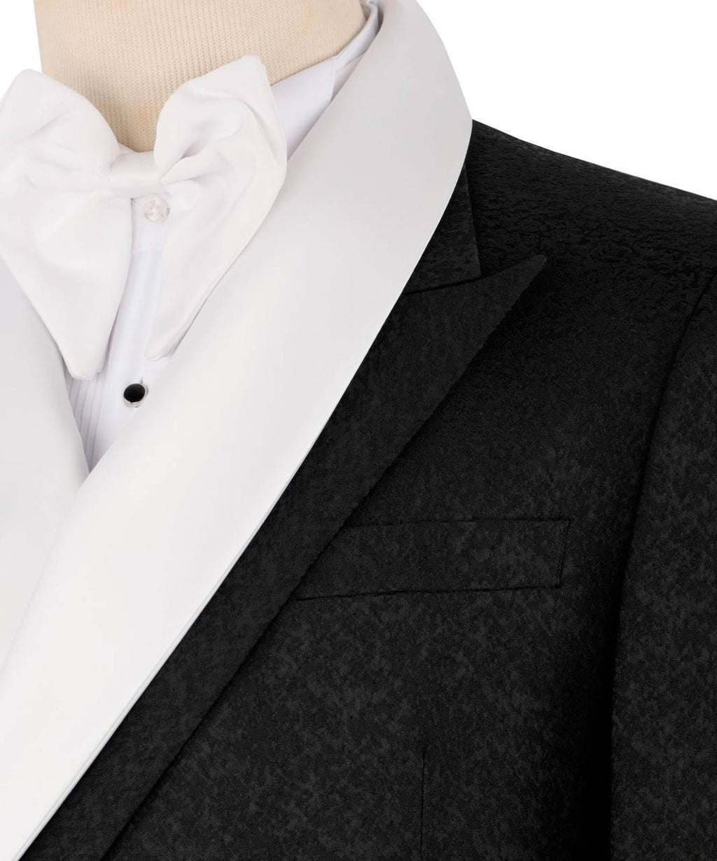 Black tuxedo jacket over a white shirt on a mannequin with a white background