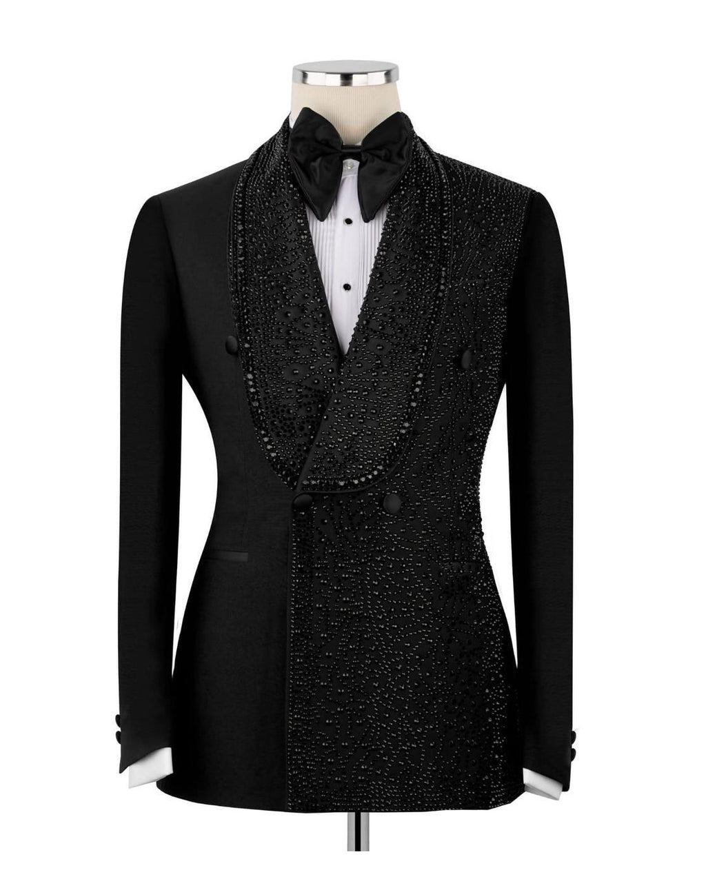 A black double-breasted tuxedo jacket with heavy bead and sequin embellishments, styled on a mannequin with a black bow tie, white pleated shirt, and black vest.