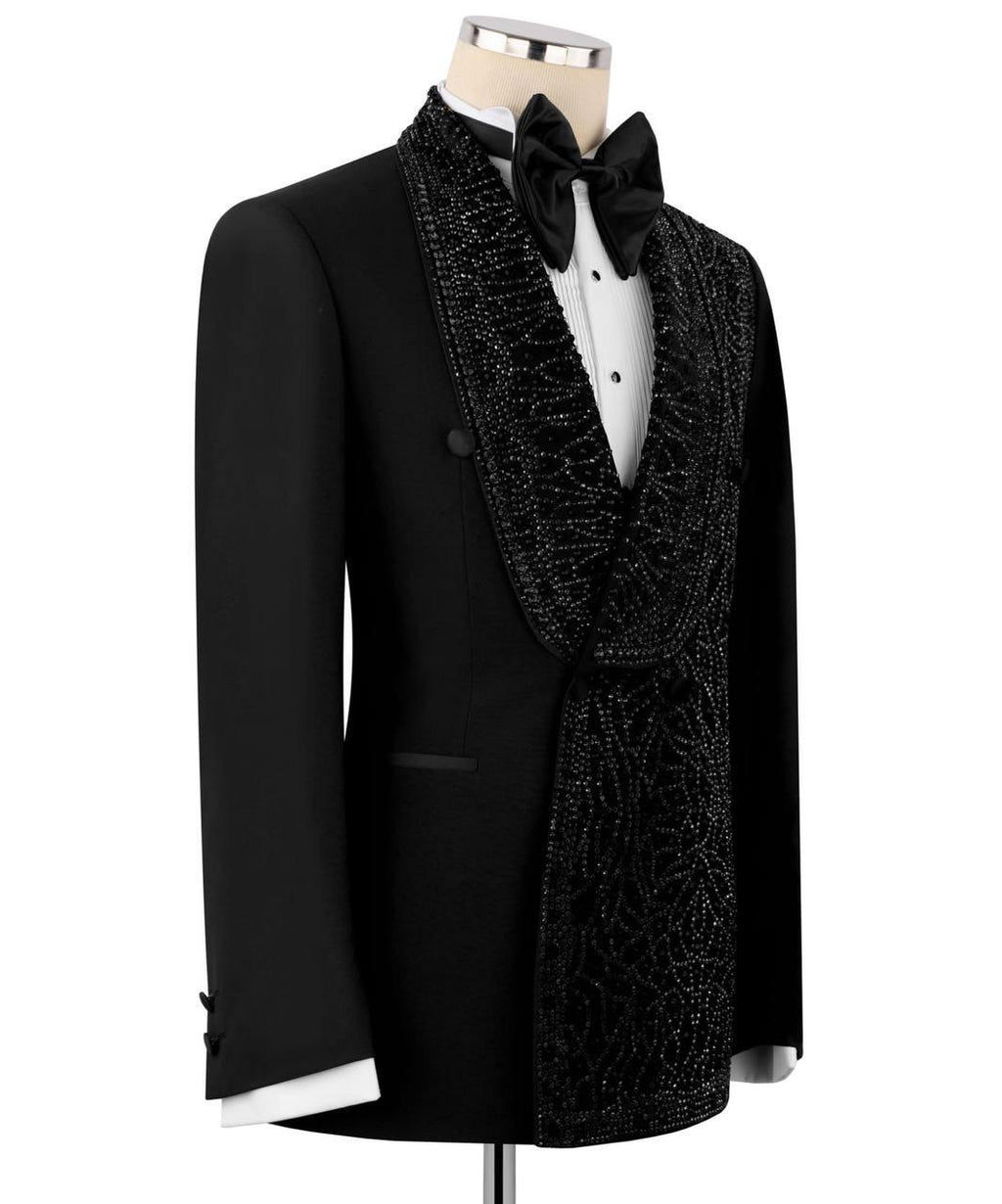 Black tuxedo with a decorative lapel on a mannequin against a white background