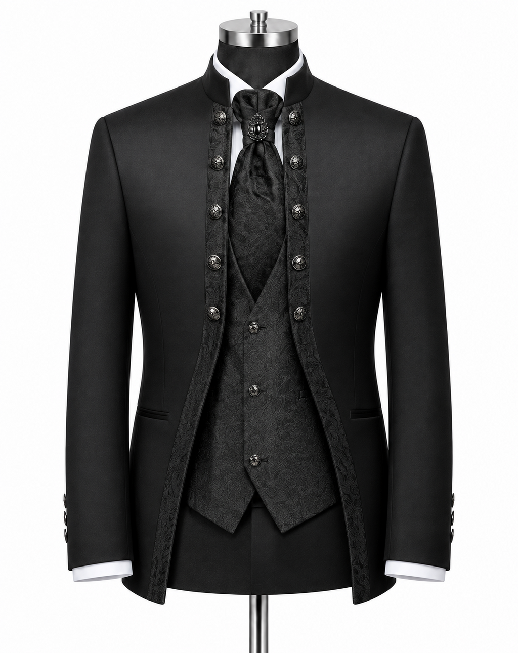 A black formal suit displayed on a mannequin, featuring a jacket with ornate silver-tone buttons, a matching patterned vest, tie, and high collar, with white shirt cuffs visible.