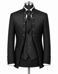 A black formal suit displayed on a mannequin, featuring a jacket with ornate silver-tone buttons, a matching patterned vest, tie, and high collar, with white shirt cuffs visible.