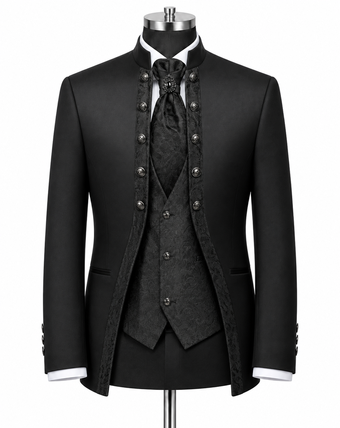 A black formal suit displayed on a mannequin, featuring a jacket with ornate silver-tone buttons, a matching patterned vest, tie, and high collar, with white shirt cuffs visible.