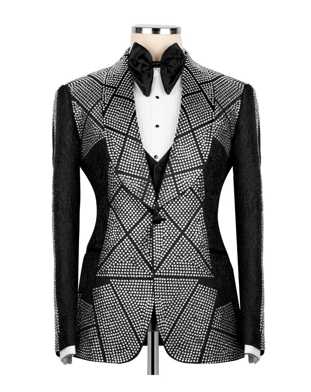 A men's tuxedo jacket with a black and white geometric rhinestone pattern, displayed on a mannequin with a black bow tie and white pleated shirt.
