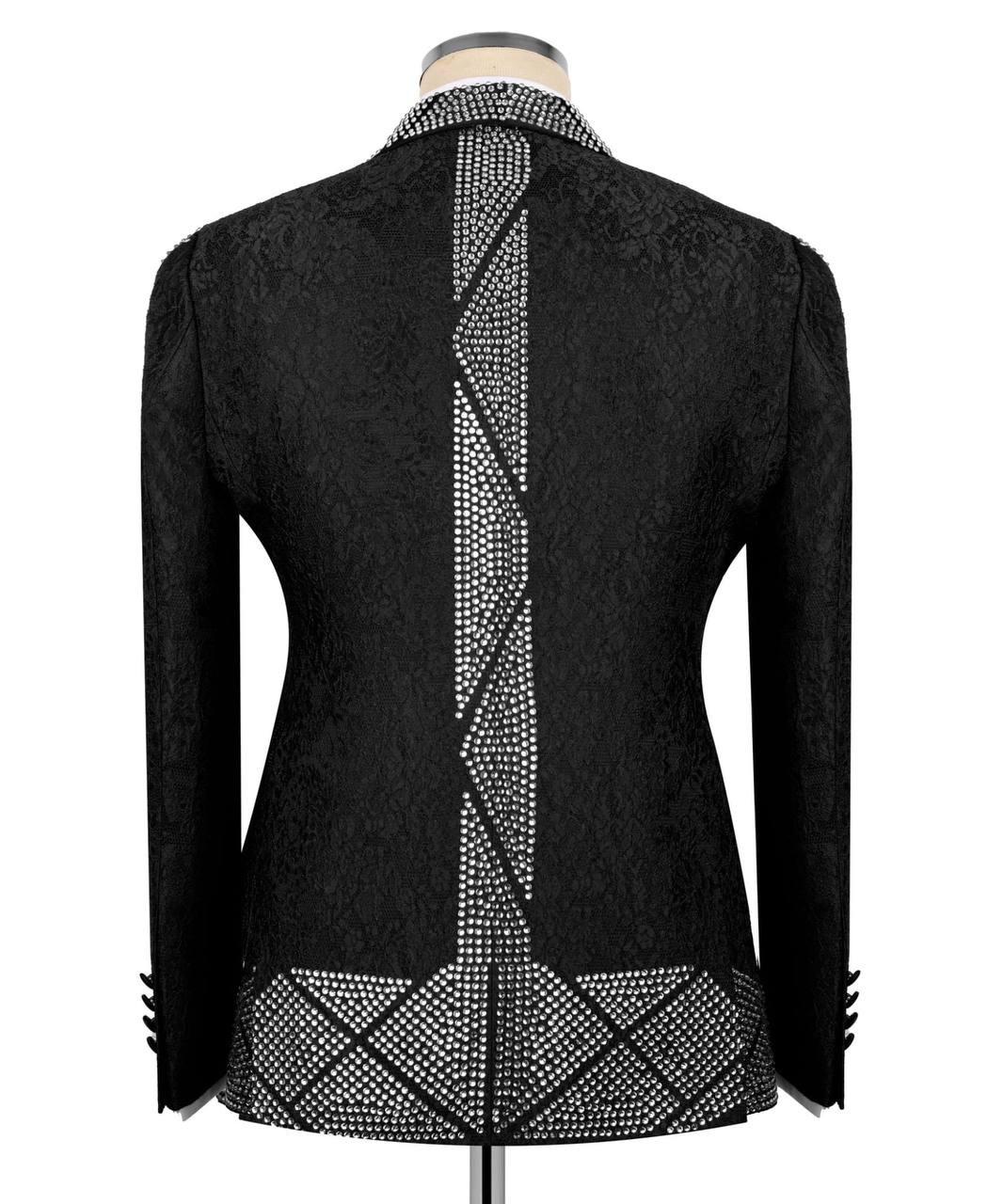 Black lace longline jacket with silver rhinestone embellishments on the back, collar, cuffs, and hem, displayed on a mannequin against a white background.