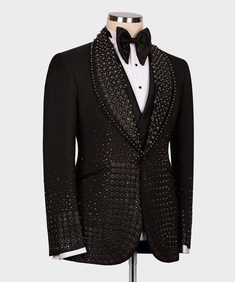 Black tuxedo with intricate detailing on a mannequin against a white background