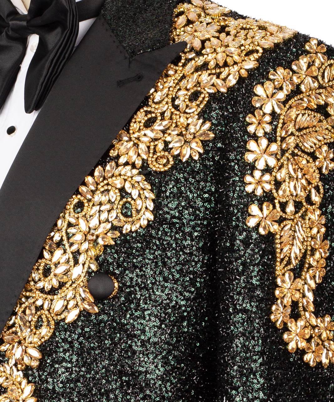 Close-up of a formal jacket or tuxedo lapel with black sequined fabric and ornate gold floral beadwork, shown with a black satin bow tie and black lapel.