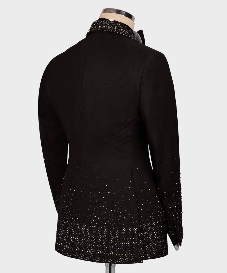 Black coat with intricate beadwork on a mannequin against a white background