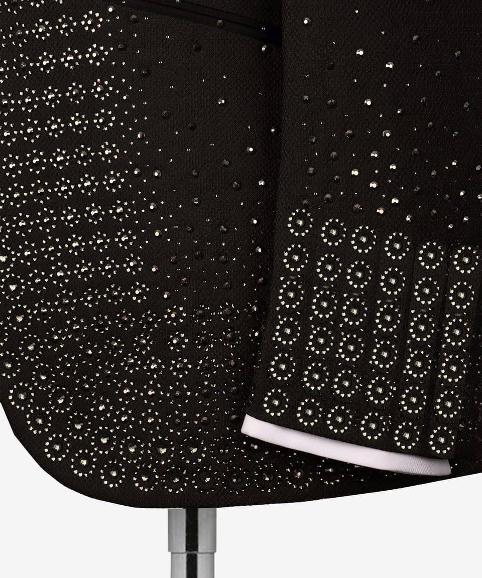 Black chair with rhinestone embellishments on a white background