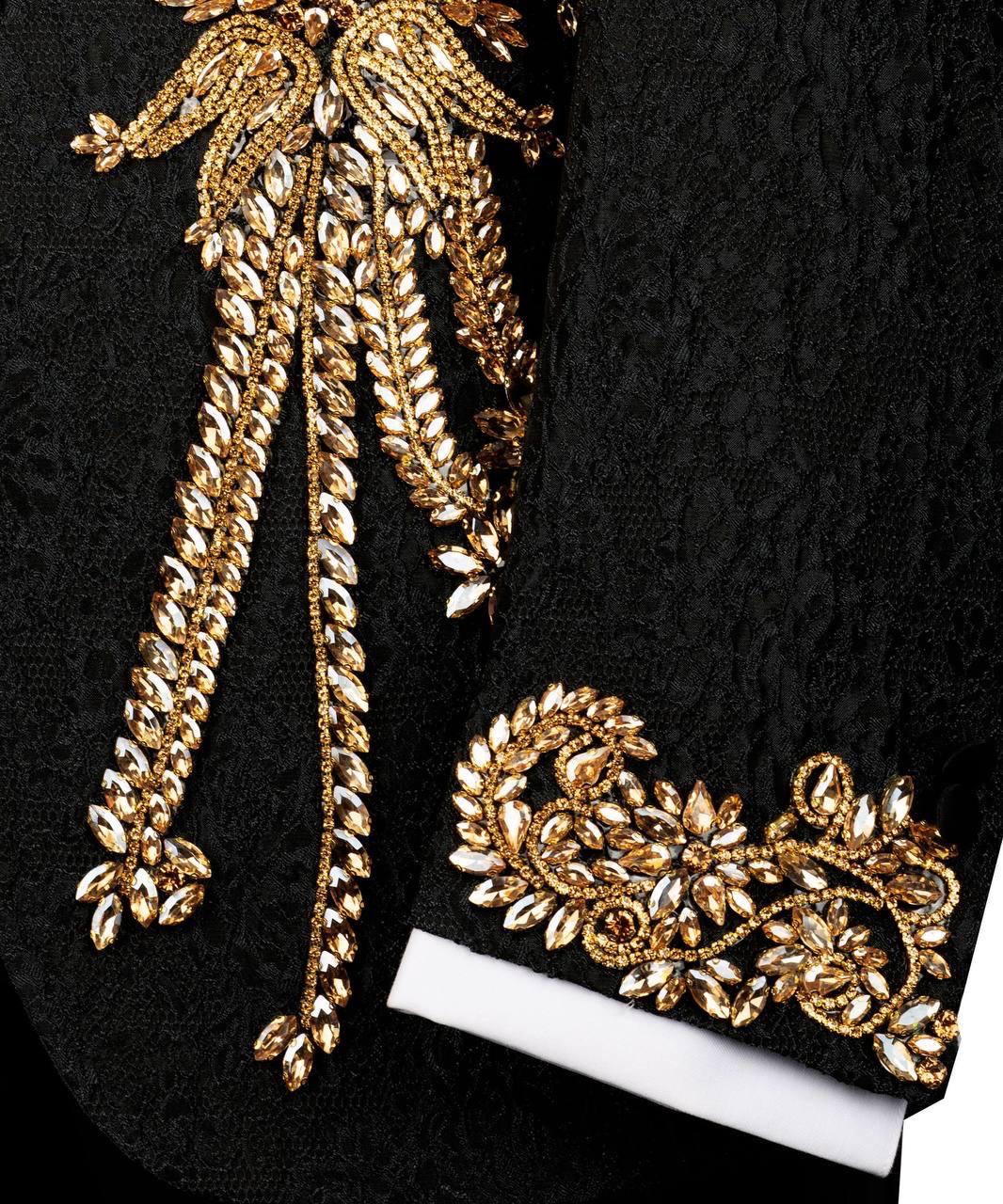 Gold embroidered design on a black fabric background