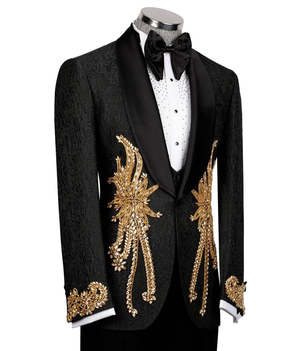 A black tuxedo jacket with ornate gold sequin and bead embroidery on the front and cuffs, displayed on a mannequin with a white shirt, black bow tie, and black trousers against a white background.