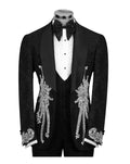 A black tuxedo jacket with ornate silver beadwork and embroidery on the front and cuffs, displayed on a mannequin with a white polka-dot shirt, black bow tie, and black vest against a plain white background.