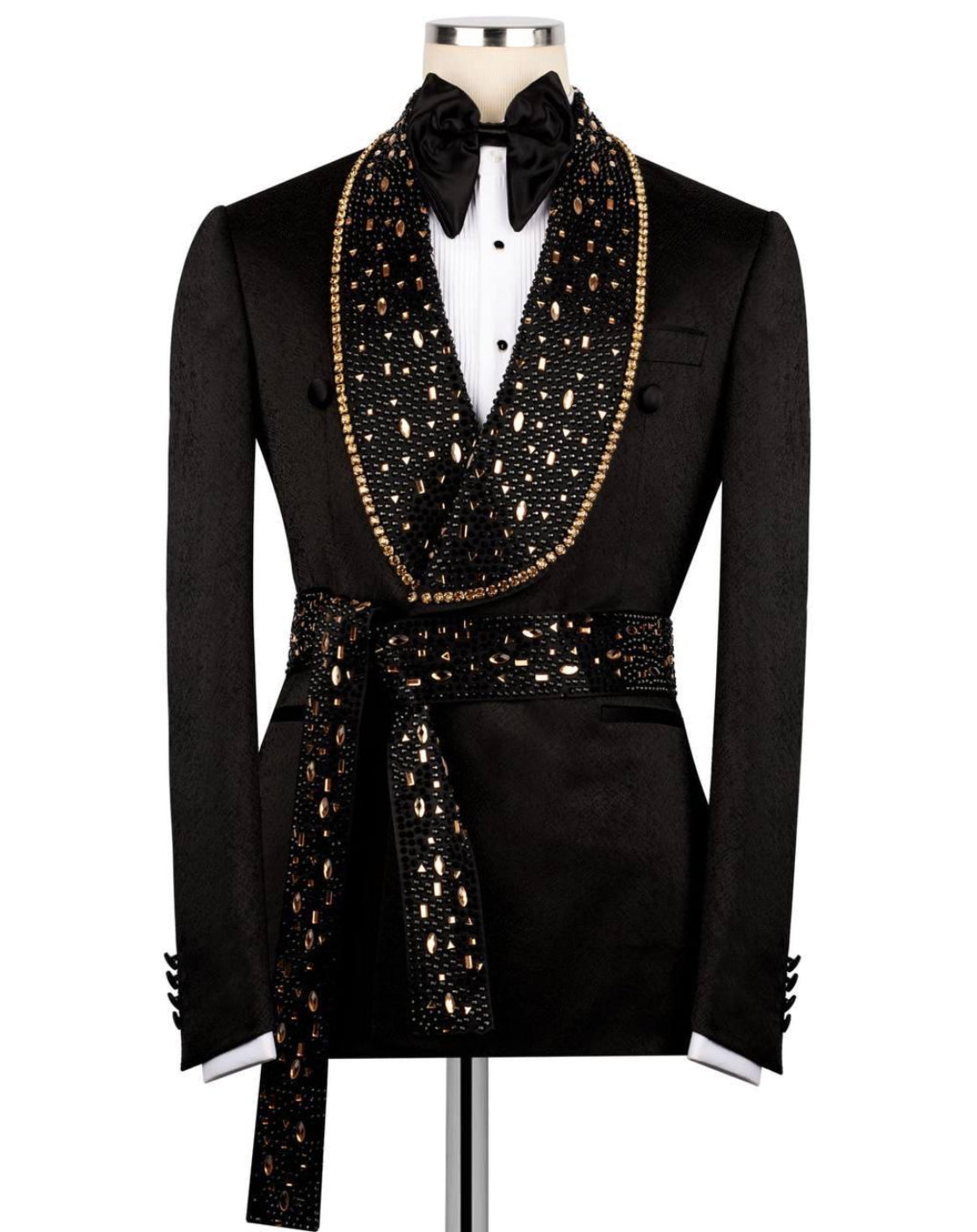 Black tuxedo with gold embellishments on a mannequin against a white background