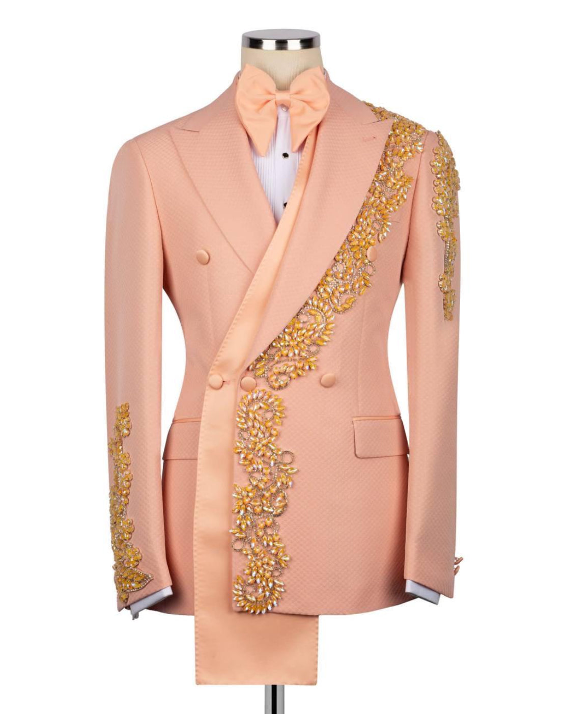 Pink suit with gold embroidery on a mannequin against a white background