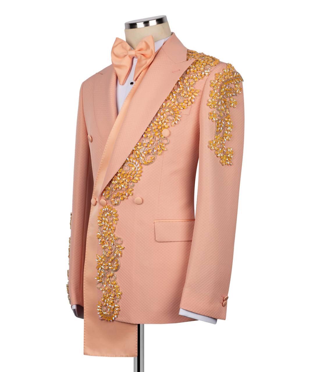 Pink blazer with gold embroidery on a mannequin against a white background