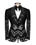 A black tuxedo jacket with ornate silver rhinestone patterns on the shawl collar, front panel, and sleeves, styled on a mannequin with a white dress shirt and black bow tie against a white background.